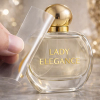Hand peeling transfer film from custom metallic gold "LADY ELEGANCE" UV DTF perfume bottle label