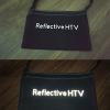 Day and night contrast showing silver reflective HTV letters glowing on black canvas bag