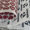 Various custom 3D silicone heat transfer film sheets showing screen printed logos and glossy heart patterns