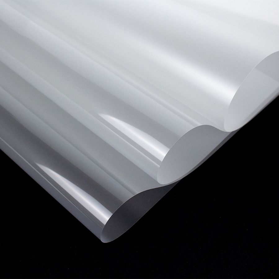 Peeling clear carrier sheet from a custom 3D high density silicone reflective heat transfer dragon logo on fabric