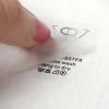 Peeling clear PET carrier film from custom printed heat transfer wash label on apparel