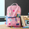 Pink school backpack decorated with custom colorful daisy flower embroidered iron-on patches