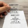 Applying clear PET film custom heat transfer neck label onto white garment fabric
