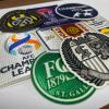 Close-up view of custom 3D flock and embroidered heat transfer patches for sportswear jerseys