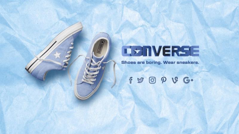 Pair of blue converse low tops against a light blue, paper background. Converse logo with a star for the "O" to the right of sneakers. Text underneath logo reads "Shoes are boring. Wear sneakers." and has social media icons.