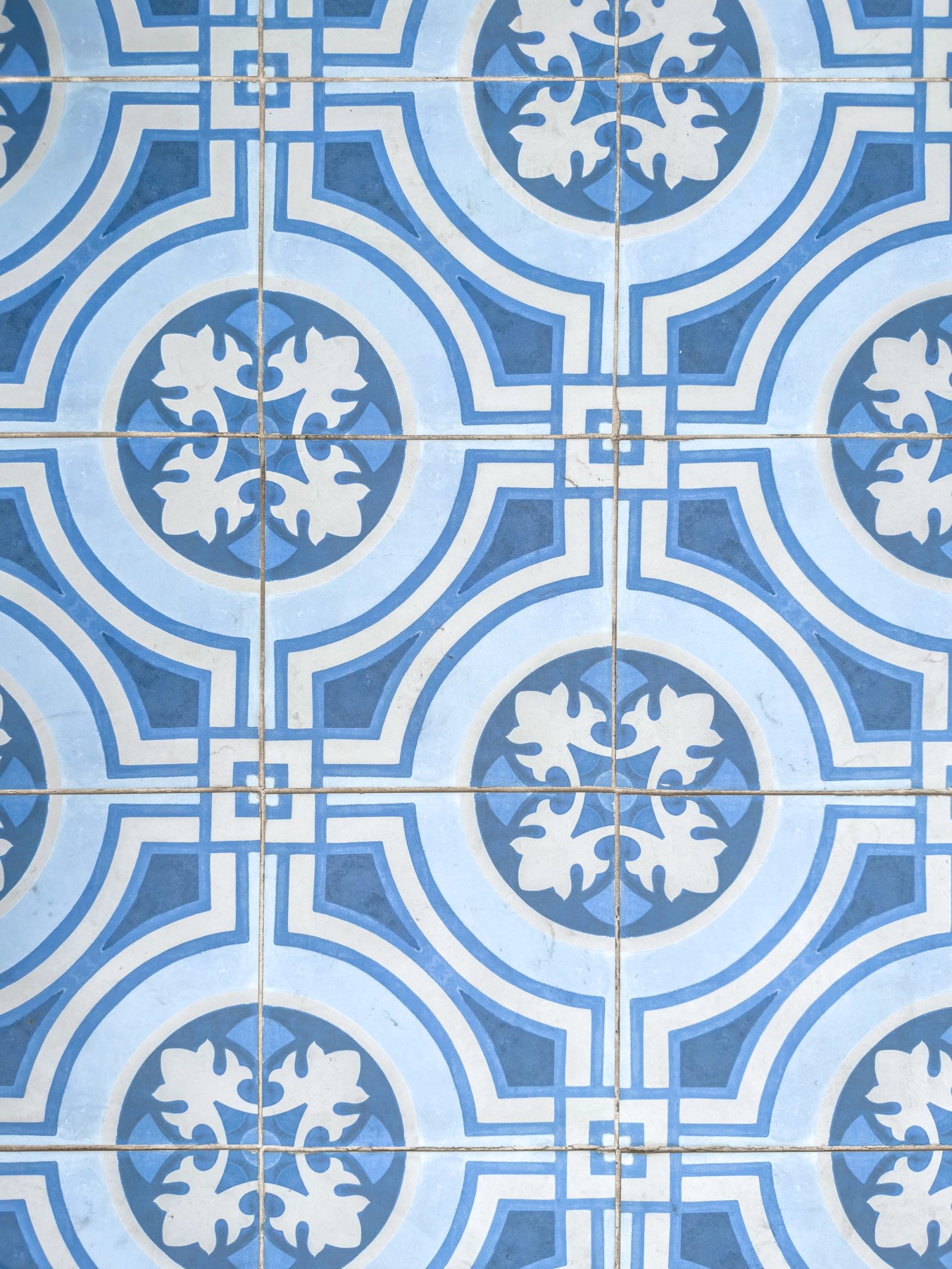 Blue and white decorative patio tile pattern.