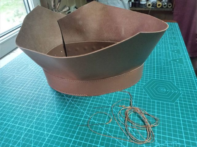 Коньячний шкіряний ремінь ручної роботи з прошитими краями та отворами для регулювання, фото на килимку для різання