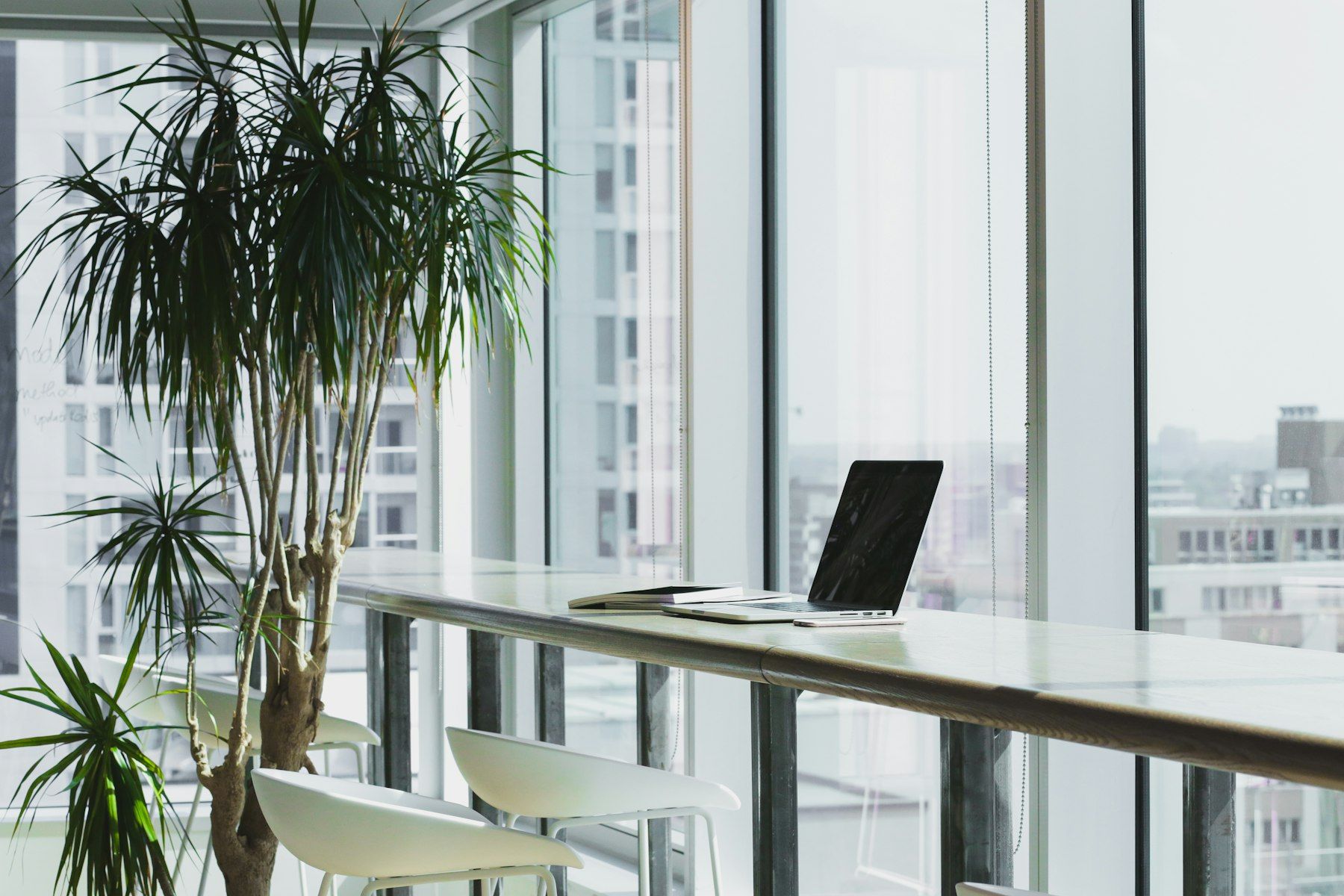A window bench with a laptop and a stack of paper