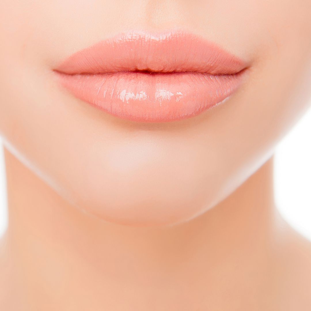 Close up photo of full woman's lips after augmentation