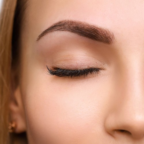 Close up view of beautiful woman with powder brows