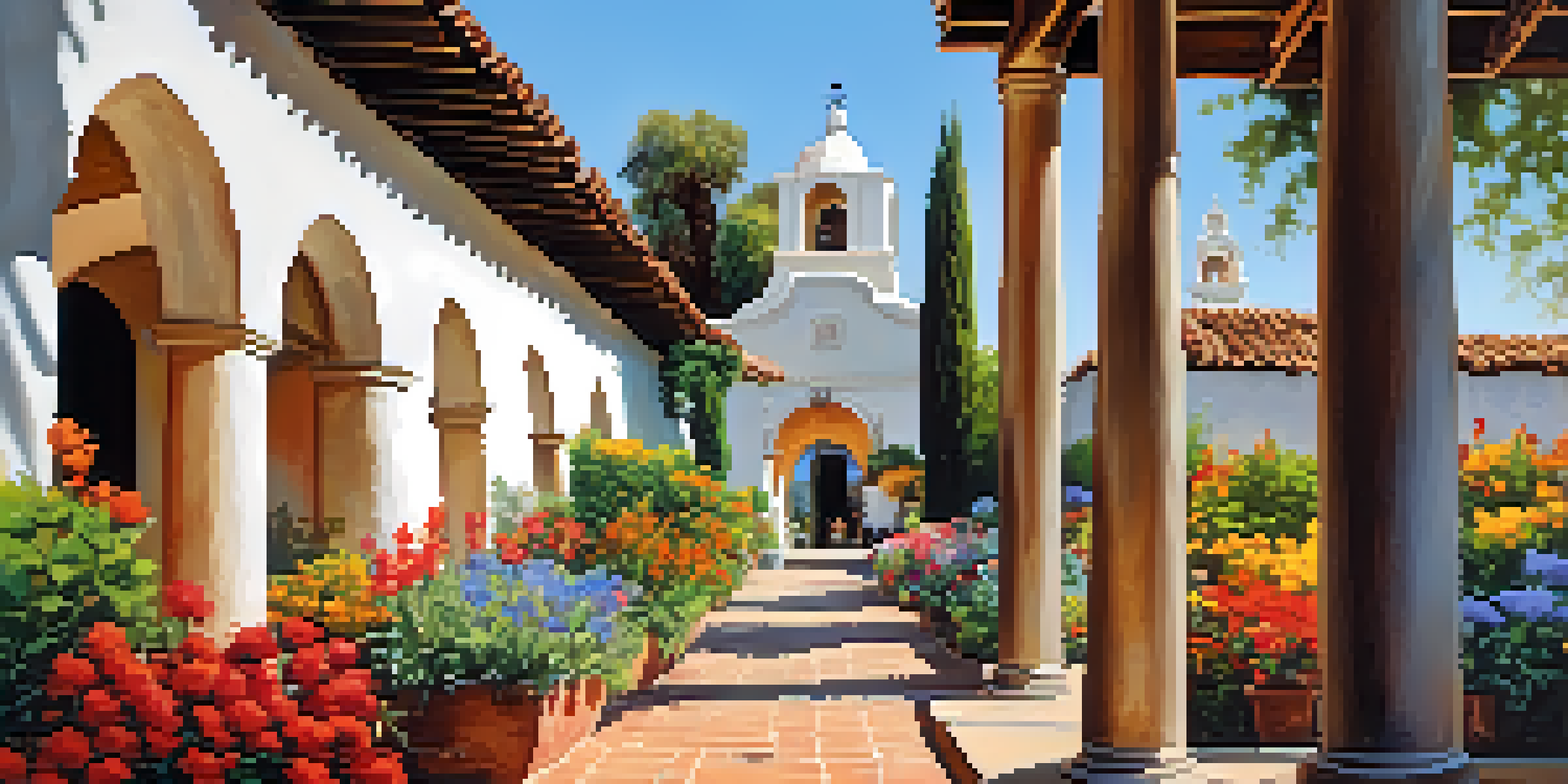 A scenic view of Mission San Diego de Alcalá with its Spanish colonial architecture and colorful gardens under a blue sky.