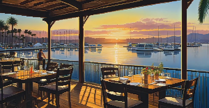 A picturesque waterfront dining scene in San Diego during sunset, with tables on a wooden deck overlooking a marina.