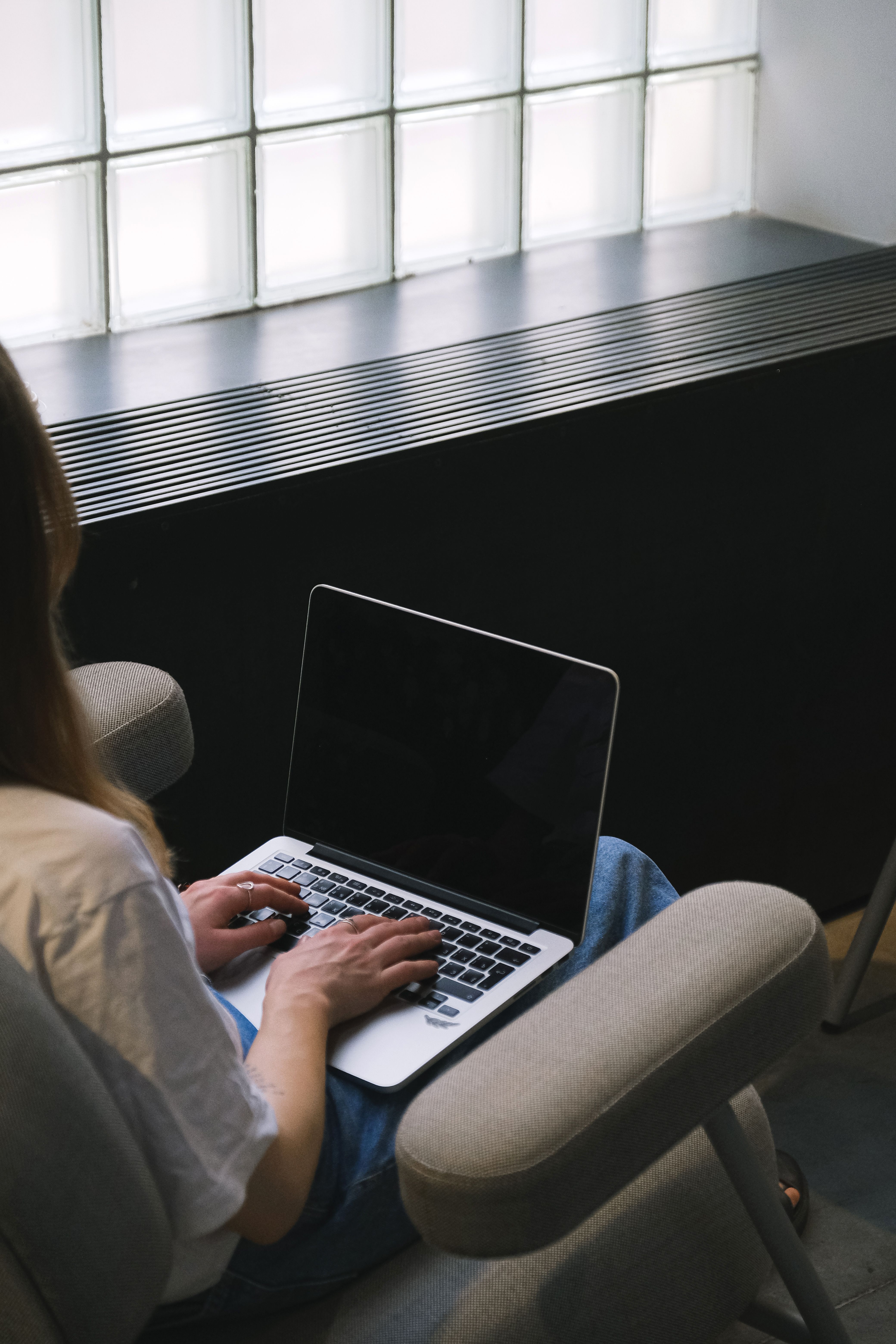 Person working on laptop modern office technology workspace