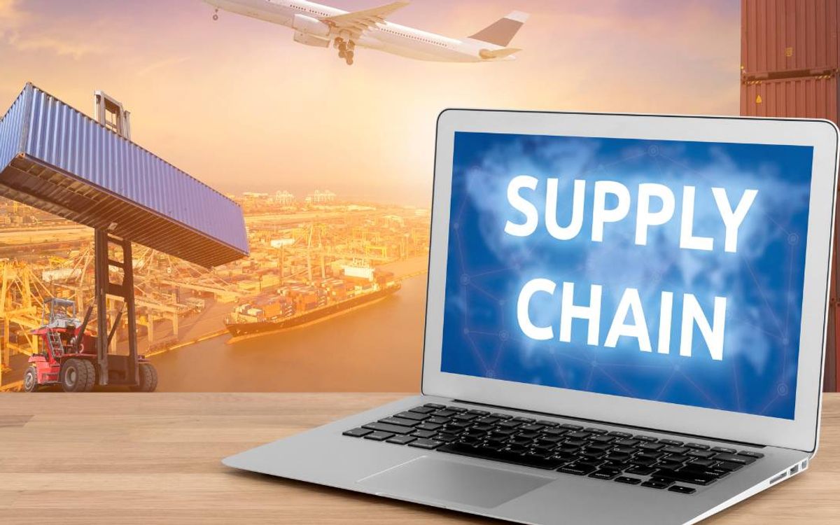 Laptop showing a supply chain network with an aircraft taking off over a container port behind it
