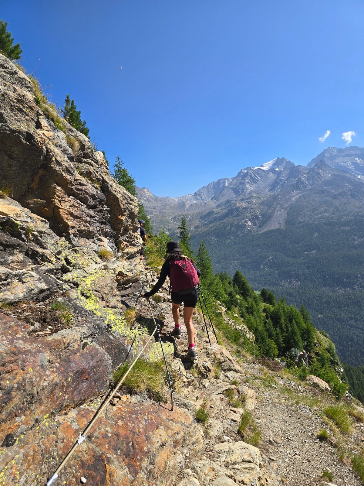 Descending a wire-rope secured rock step on the Day 1 ledges