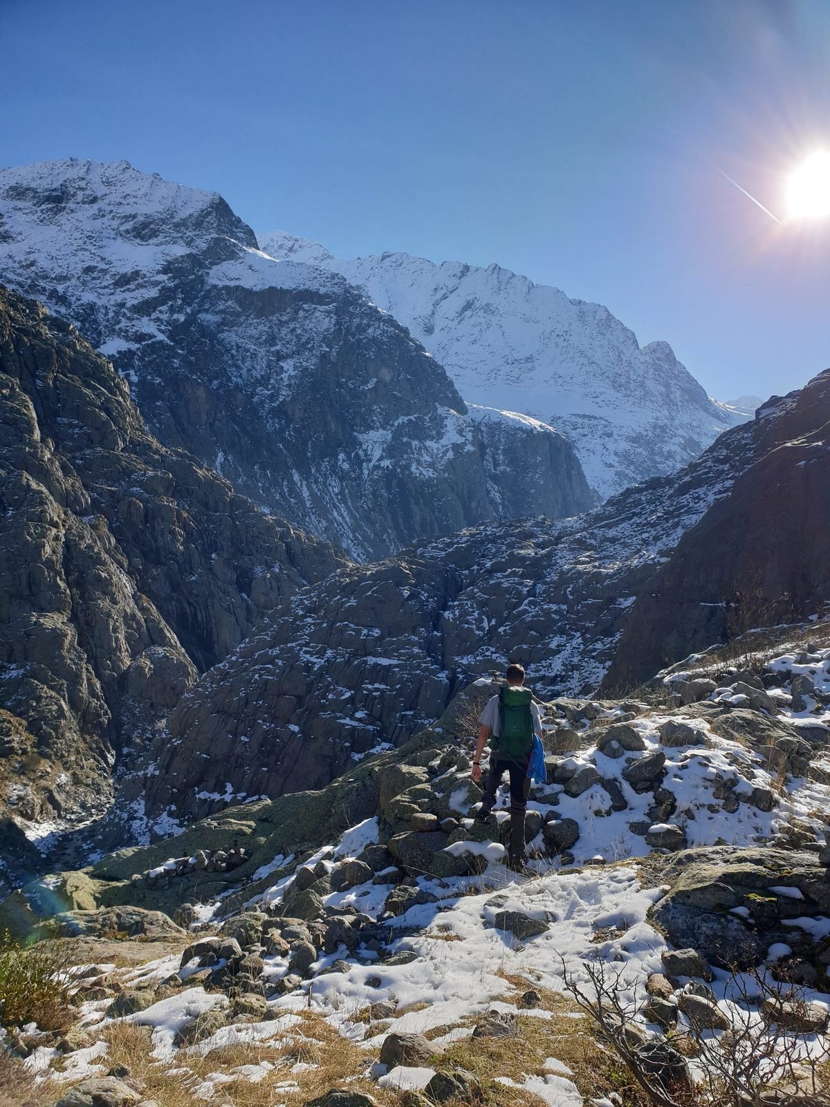 The rocky trail climbing toward snowy peaks above the Trift valley