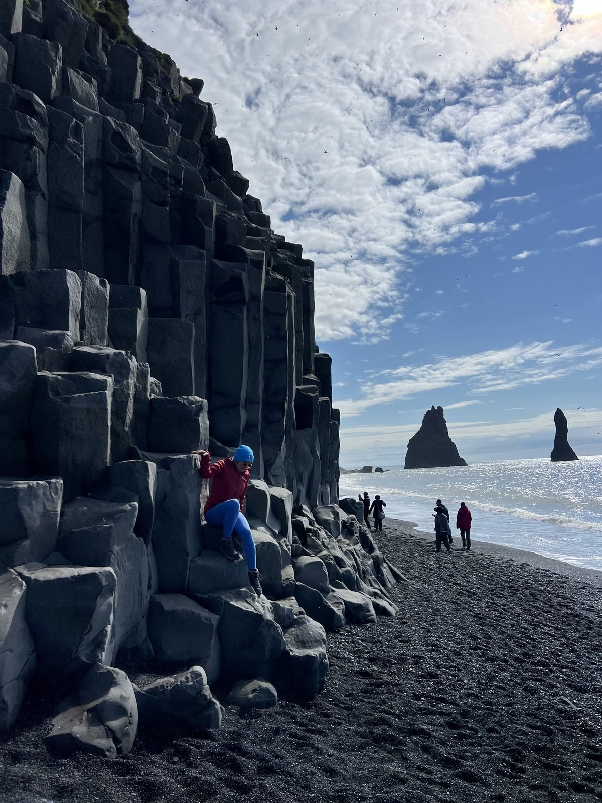 Basalt columns at Reynisfjara with the Reynisdrangar sea stacks beyond