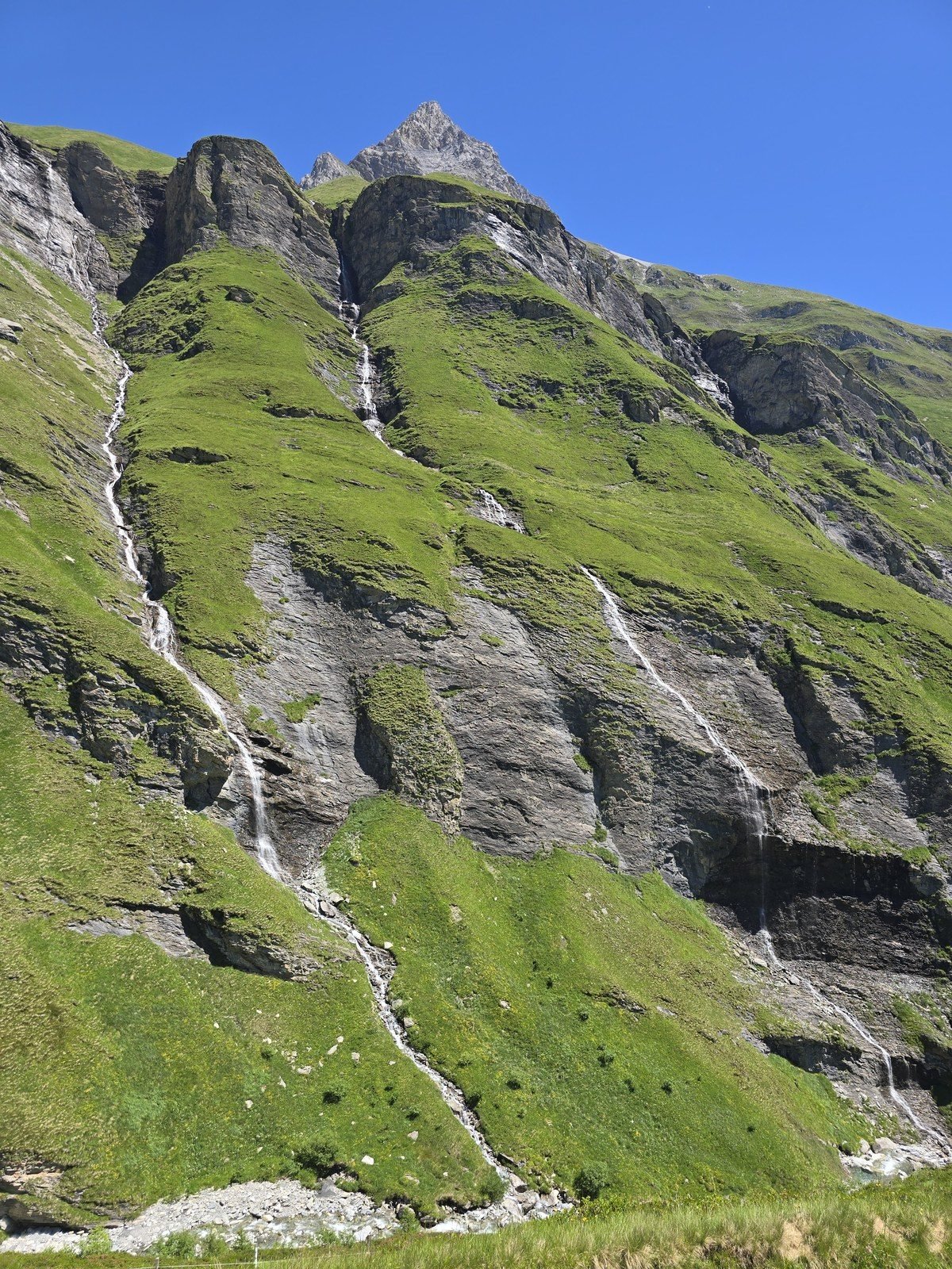 Waterfalls threading the cliffs above the Rabiusa