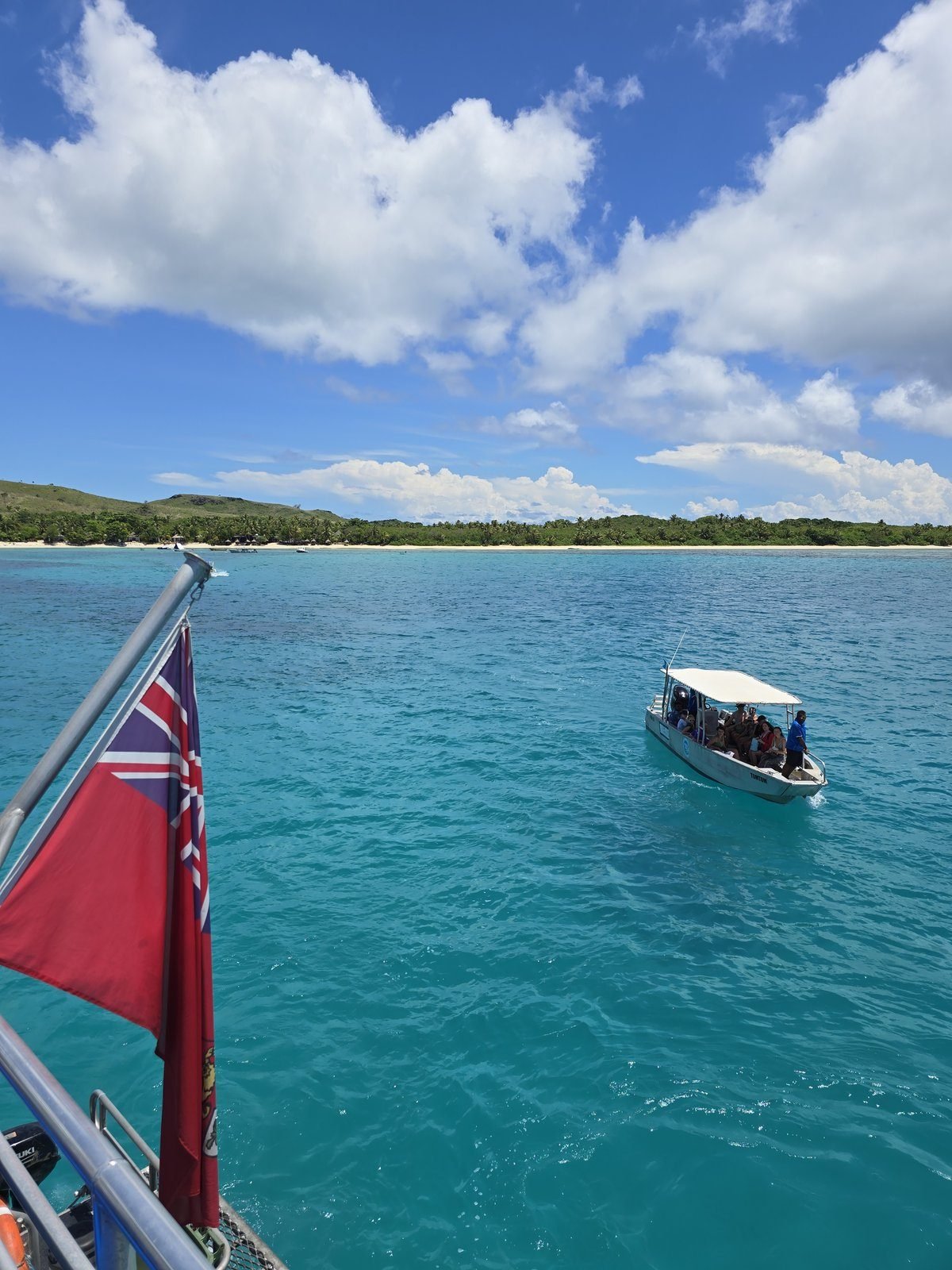A resort transfer boat on turquoise water off the reef