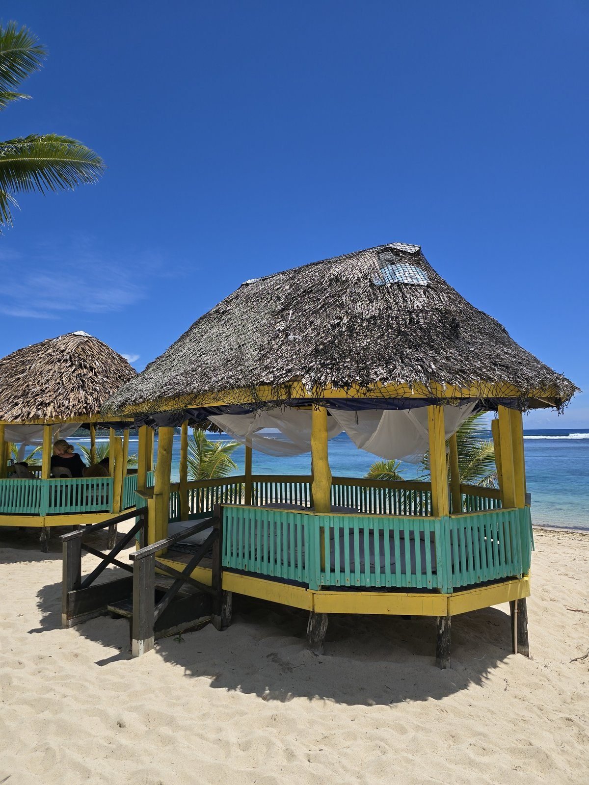 A thatched beach fale pavilion on the sand