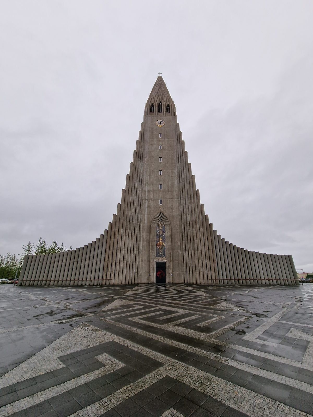 Hallgrímskirkja seen head-on from the plaza, its stepped concrete façade filling the frame