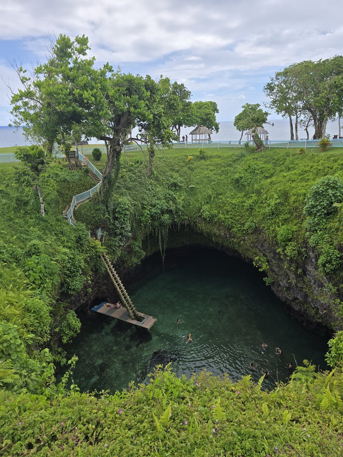 To-Sua Ocean Trench from the rim, the ladder down to swimmers in the green pool