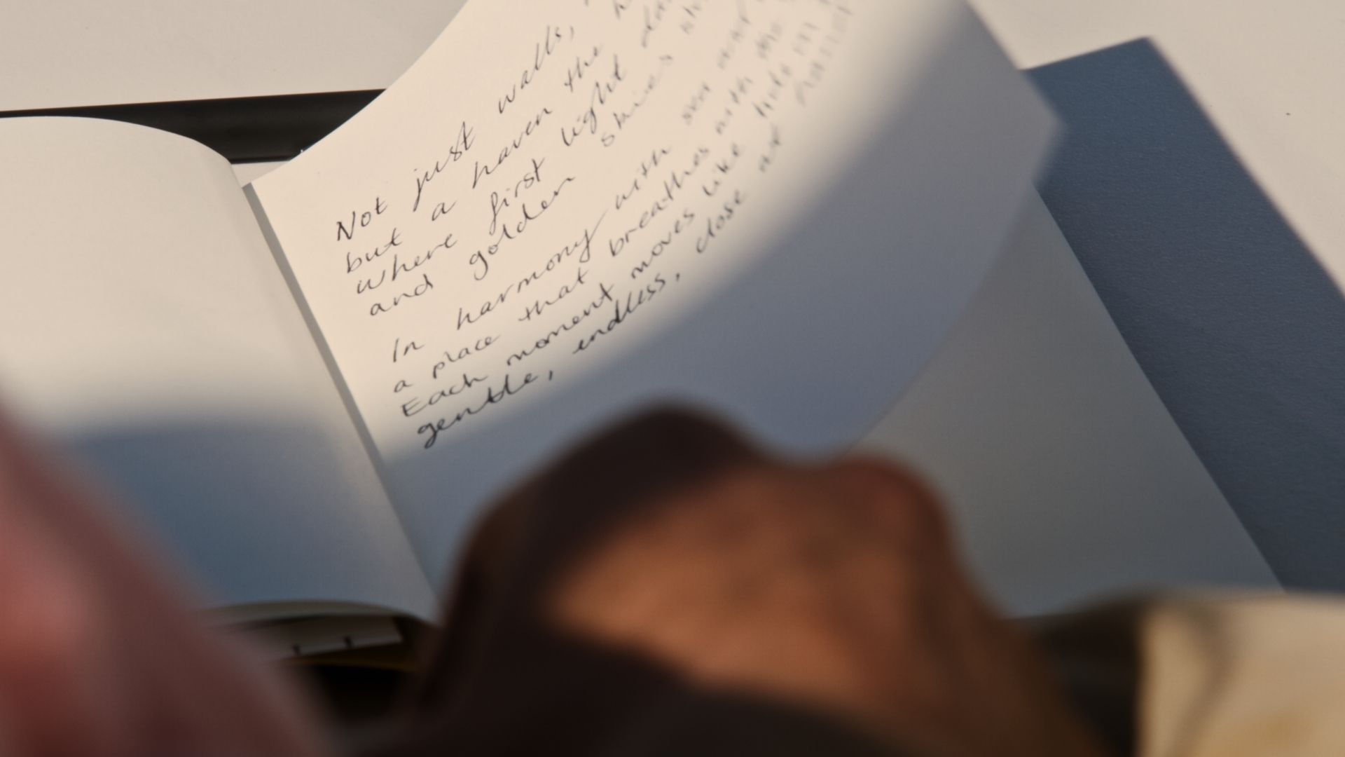 A page containing the words of a poem, blowing in the breeze.  | The International, Brighton developed by Landream & V-Leader | Architecture by Carr | Architectural Film by Veeral Patel
