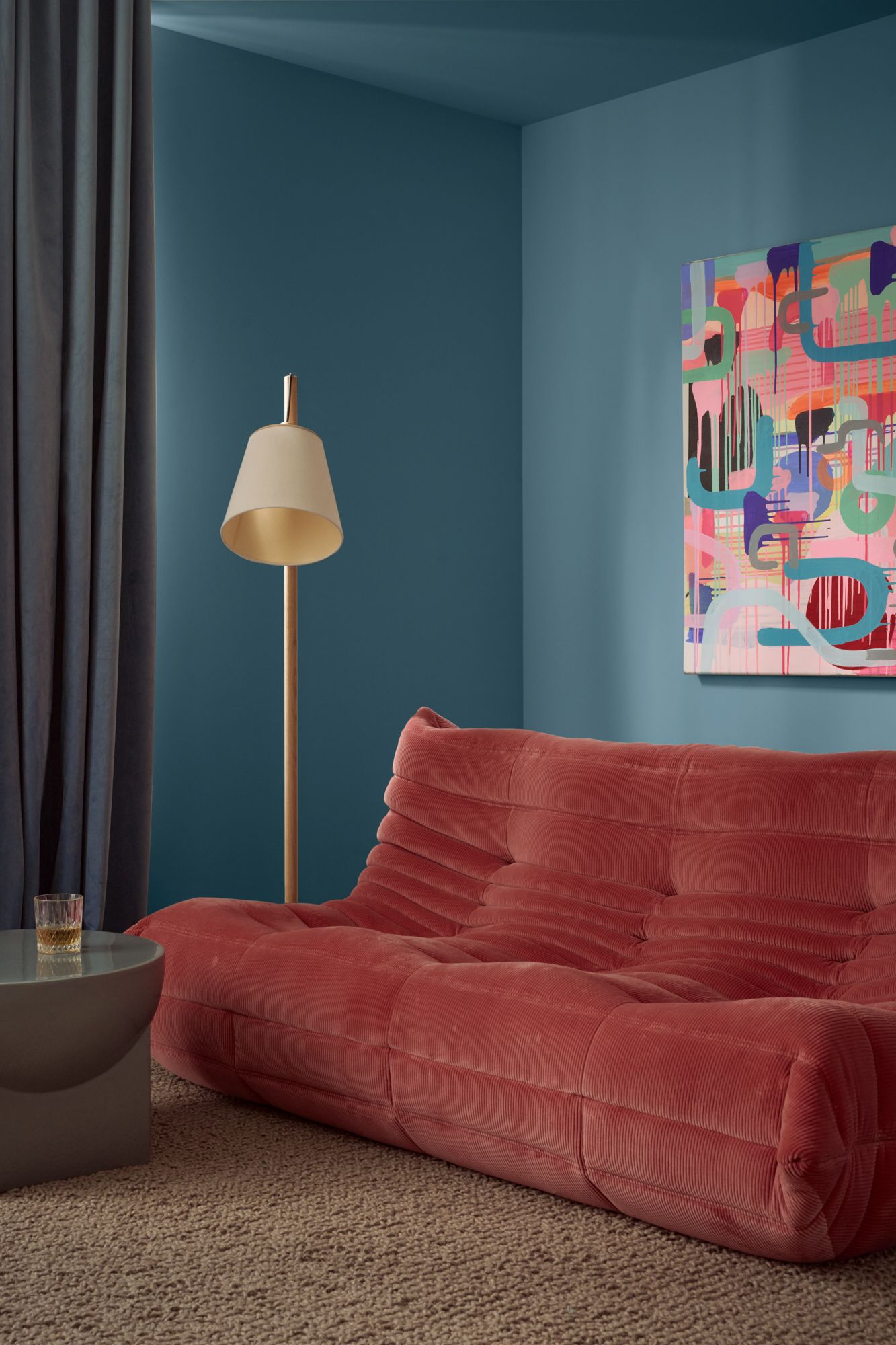 An interior view of the secondary living room with blue walls and a pink Linget Rosset Togo sofa from Domo. | Peavey Residence II by FYC Architects and Snakes & Ladders Projects | Prahran | Veeral Patel
