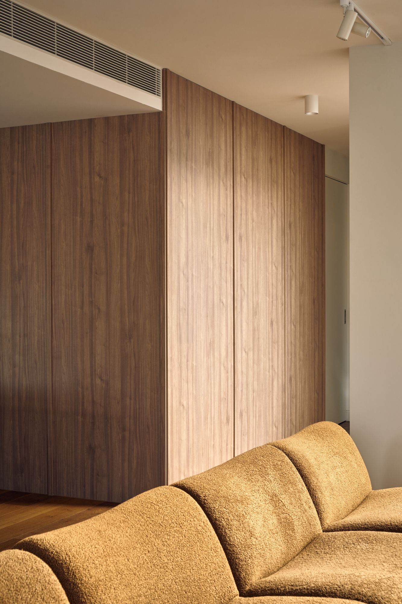 A brown couch with joinery.| Peavey Residence II by FYC Architects and Snakes & Ladders Projects | Prahran | Veeral Patel