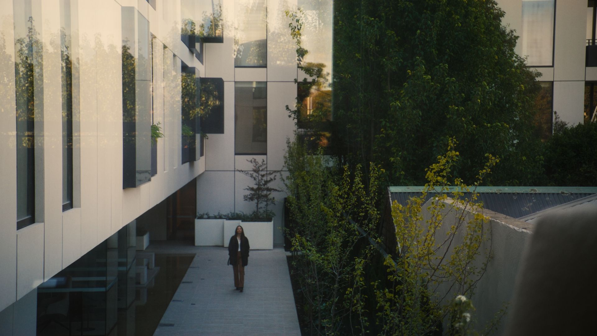 A person walking through The International, Brighton.  | The International, Brighton developed by Landream & V-Leader | Architecture by Carr | Architectural Film by Veeral Patel