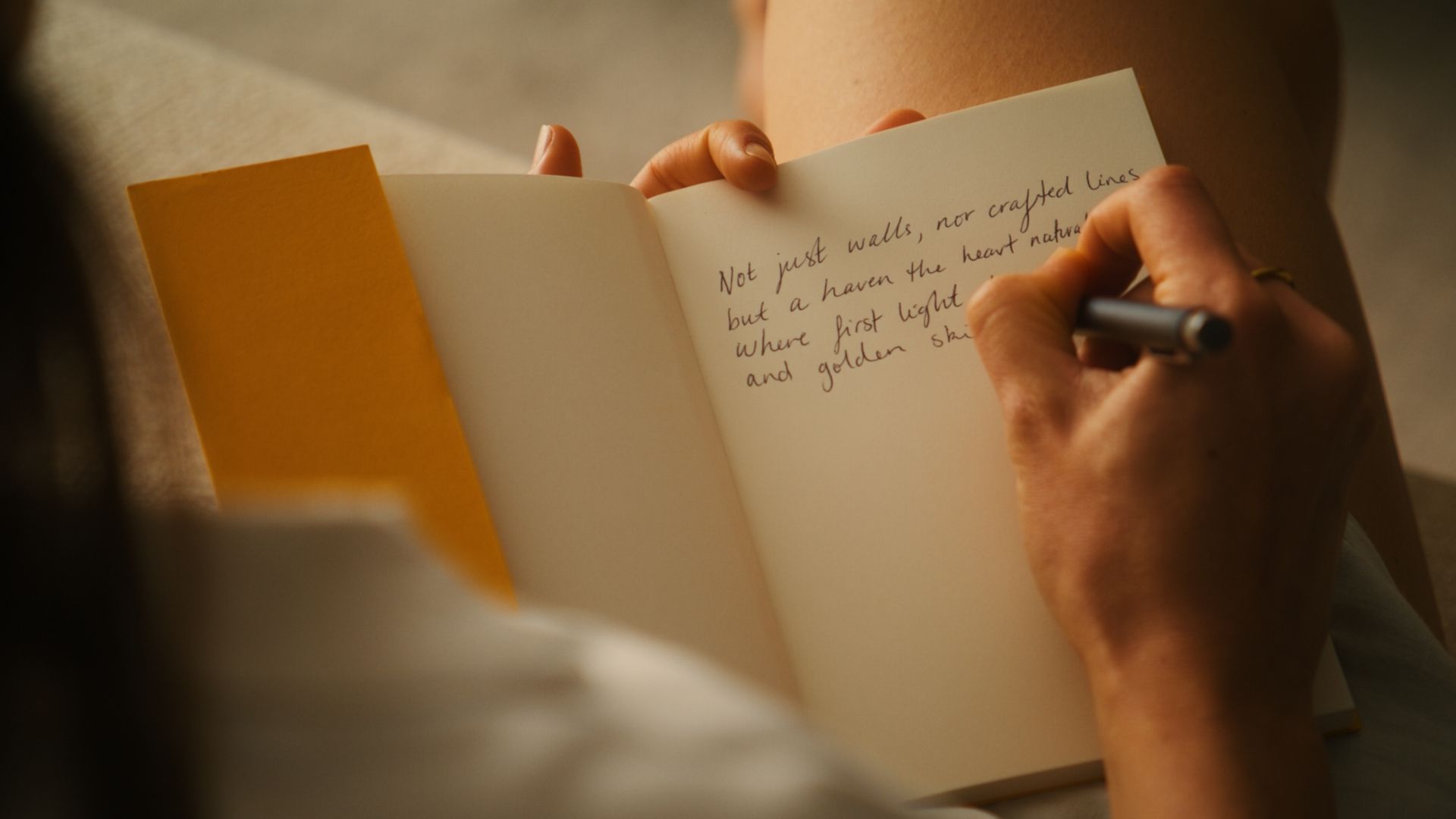 Writing a poem in a notebook. | The International, Brighton developed by Landream & V-Leader | Architecture by Carr | Architectural Film by Veeral Patel