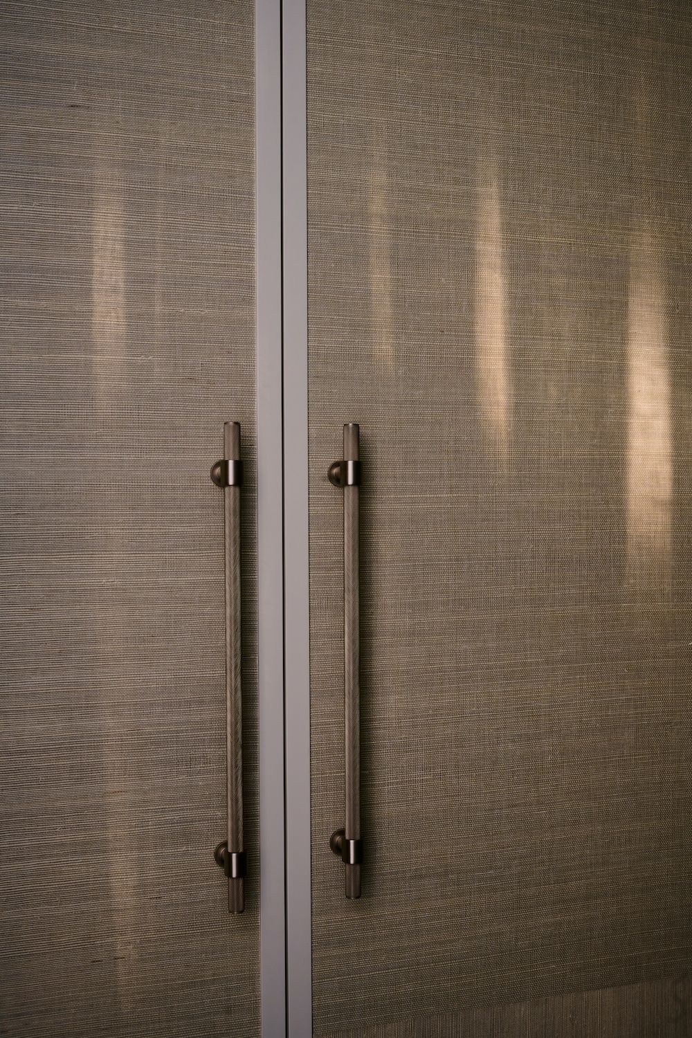 Walk-in wardrobe details. Afternoon light on the cabinet with brass door handles.  | Straun Residences interior architecture by Mim Design and built by Virgon Constructions | Mim Design | Toorak, Victoria | Architectural Photography Veeral Patel