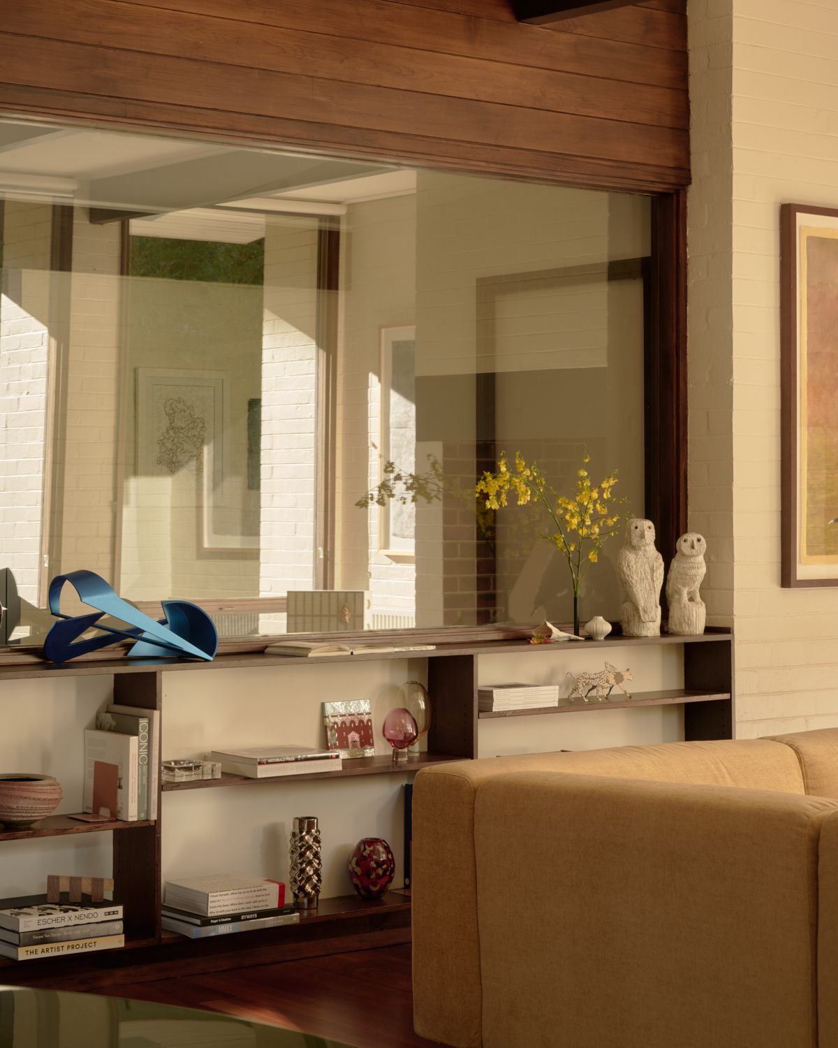 A huge expanse of glass separating the living room of Wildwood from the hallway. A garden view of Wildwood showing the depth of the colonnades. | Wildwood design by Robin Boyd | Vermont, Victoria | Midcentury Architecture | Architectural Photography by Veeral Patel 
