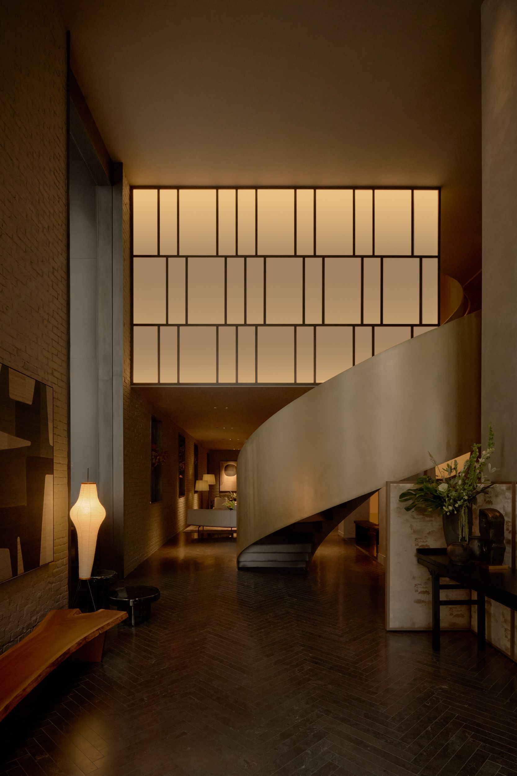 Entrance to AKA Nomad showing the curve bronze staircase and the Japanese inspired screen. | AKA Hotel Nomad, New York | Architecture and Interiors by Lissoni Partners | Photography by Veeral Patel