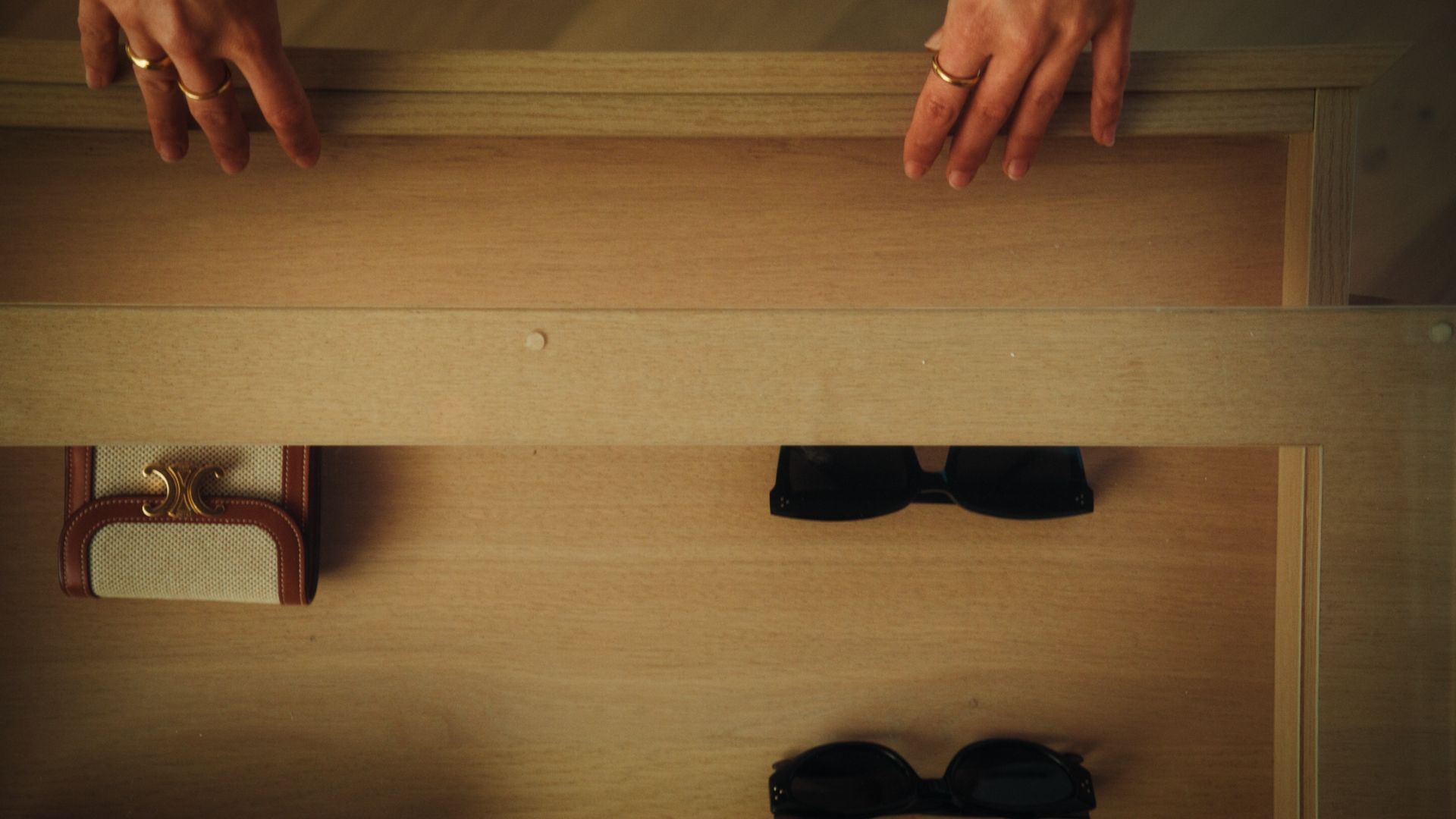 Opening a drawer with sunglasses and wallet inside the master bedroom at The International, Brighton.  | The International, Brighton developed by Landream & V-Leader | Architecture by Carr | Architectural Film by Veeral Patel