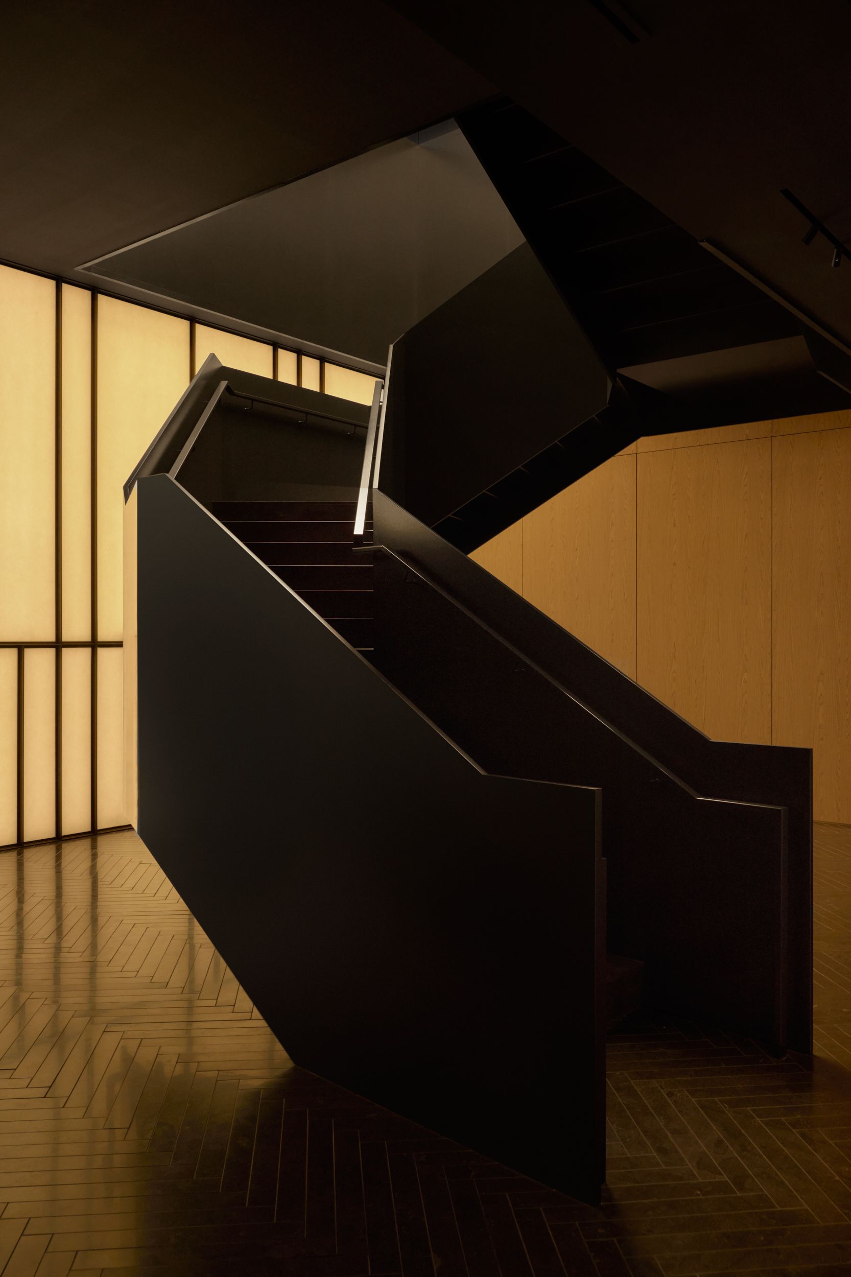 The folded metal staircase against the mid-century inspired Japanese screen. | AKA Hotel Alexandria | Alexandria, Virginia, USA | Architecture and Interiors by Lissoni Partners | Photography by Veeral Patel