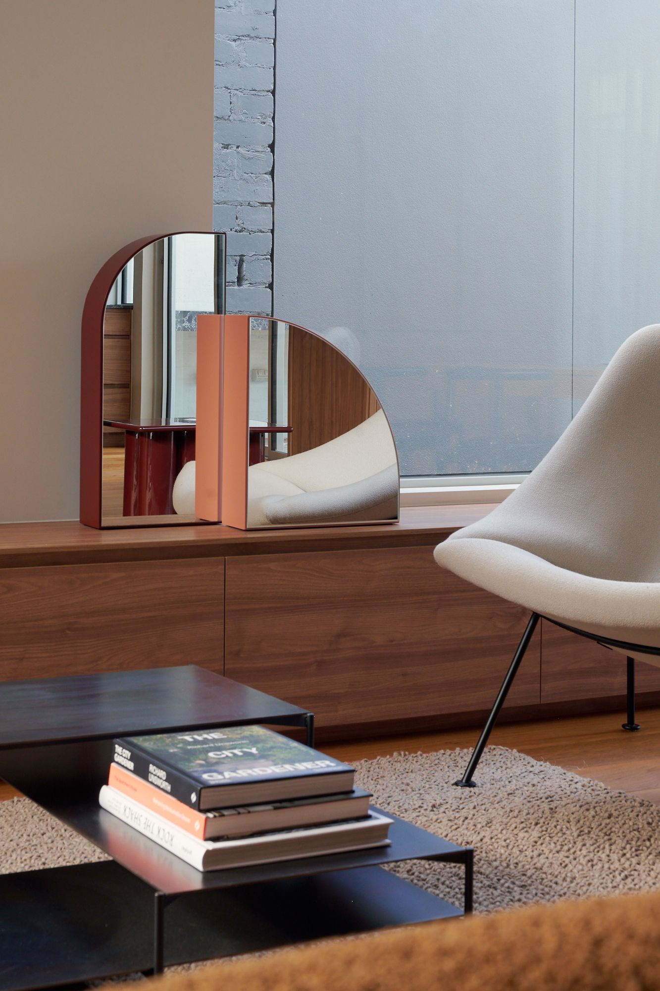 A close of the plinth with mirrored objects and a portion of the arm chair from Domo Living.   | Peavey Residence II by FYC Architects and Snakes & Ladders Projects | Prahran | Veeral Patel