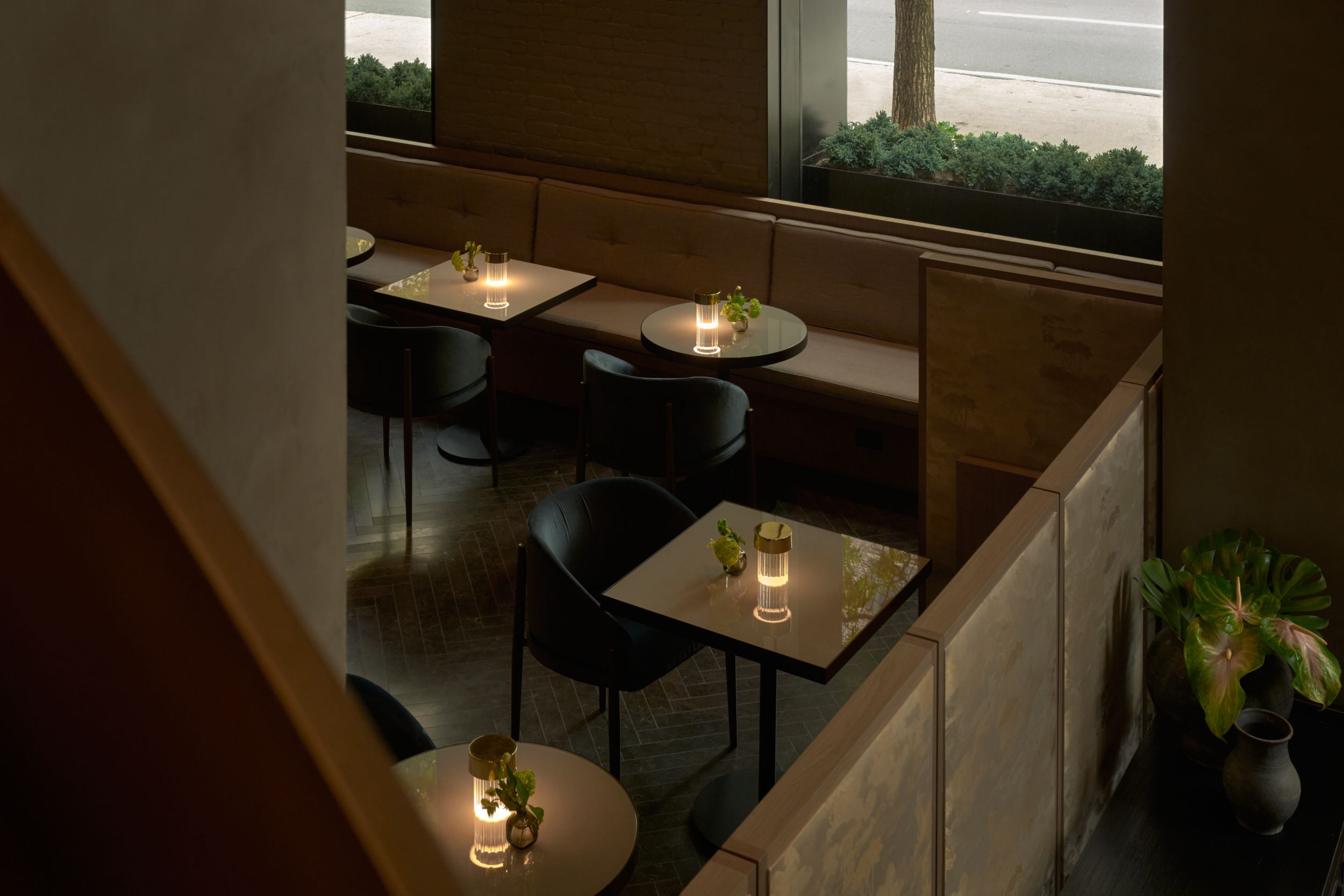 A view from above into the seating area of the bar. The bar of AKA Nomad, featuring the triple height chandelier. | AKA Hotel Nomad, New York | Architecture and Interiors by Lissoni Partners | Photography by Veeral Patel 