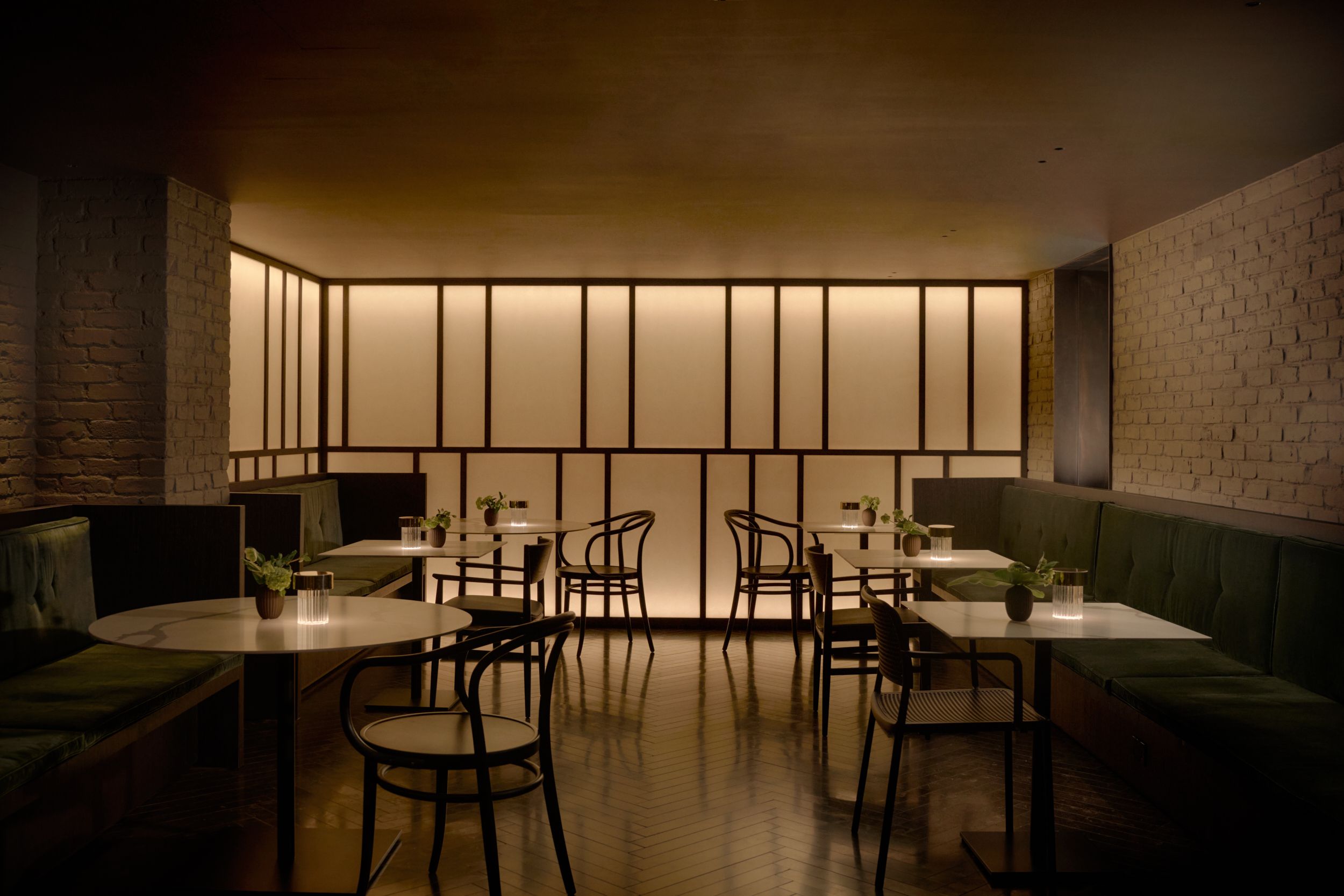 Inside the dining room of AKA Nomad hotel, the warm glow through the Japanese screens. The bar of AKA Nomad, featuring the triple height chandelier. | AKA Hotel Nomad, New York | Architecture and Interiors by Lissoni Partners | Photography by Veeral Patel 