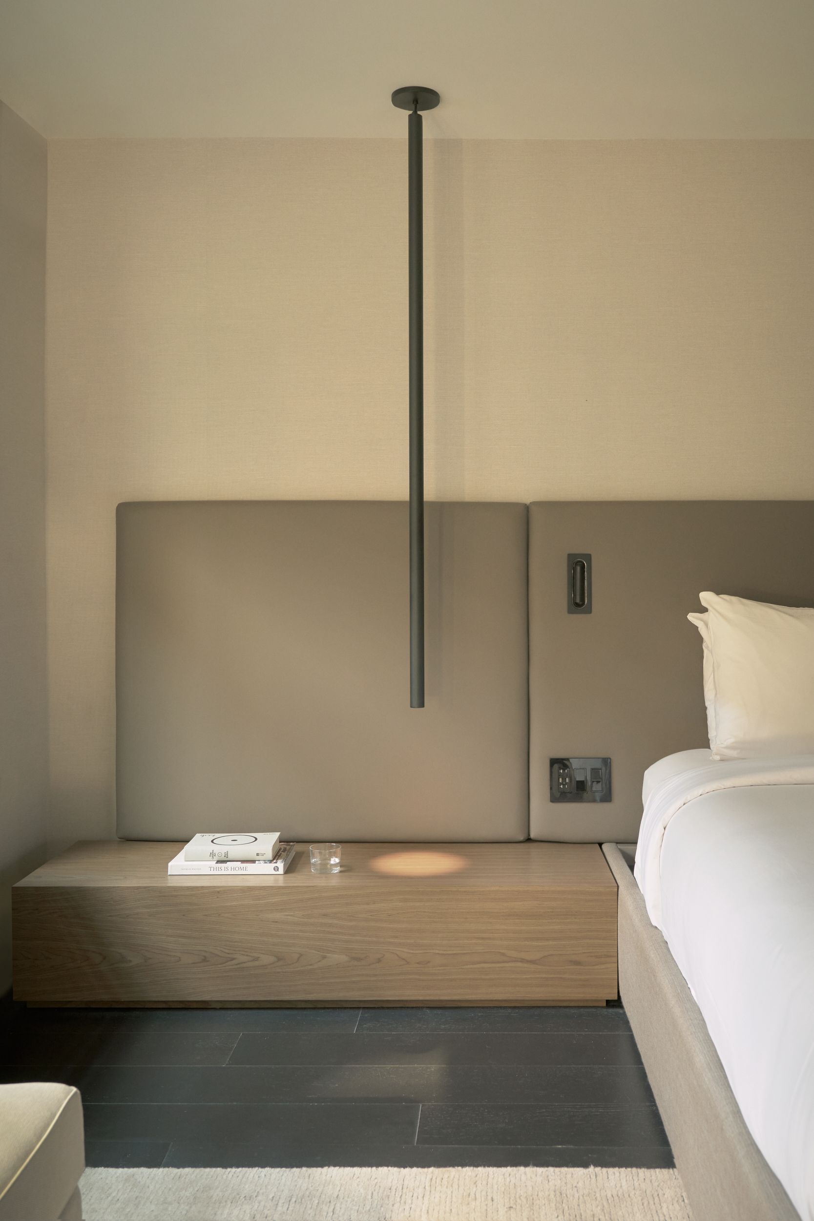 The guest room inside AKA Alexandria. The seating area alongside the glass wall of the restaurant of AKA Alexandria.  | AKA Hotel Alexandria | Alexandria, Virginia, USA | Architecture and Interiors by Lissoni Partners | Photography by Veeral Patel