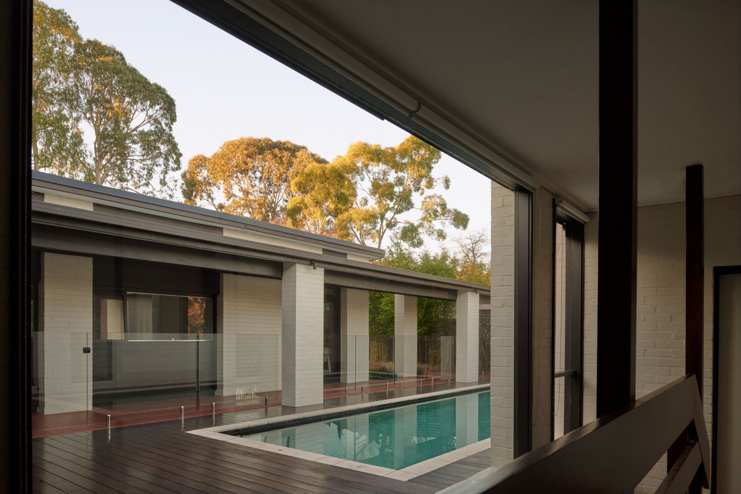 Looking at the main pavillion across the swimming pool in the central courtyard. | Wildwood by Robin Boyd | Vermont, Victoria | Noble family | Architectural Photography by Veeral Patel