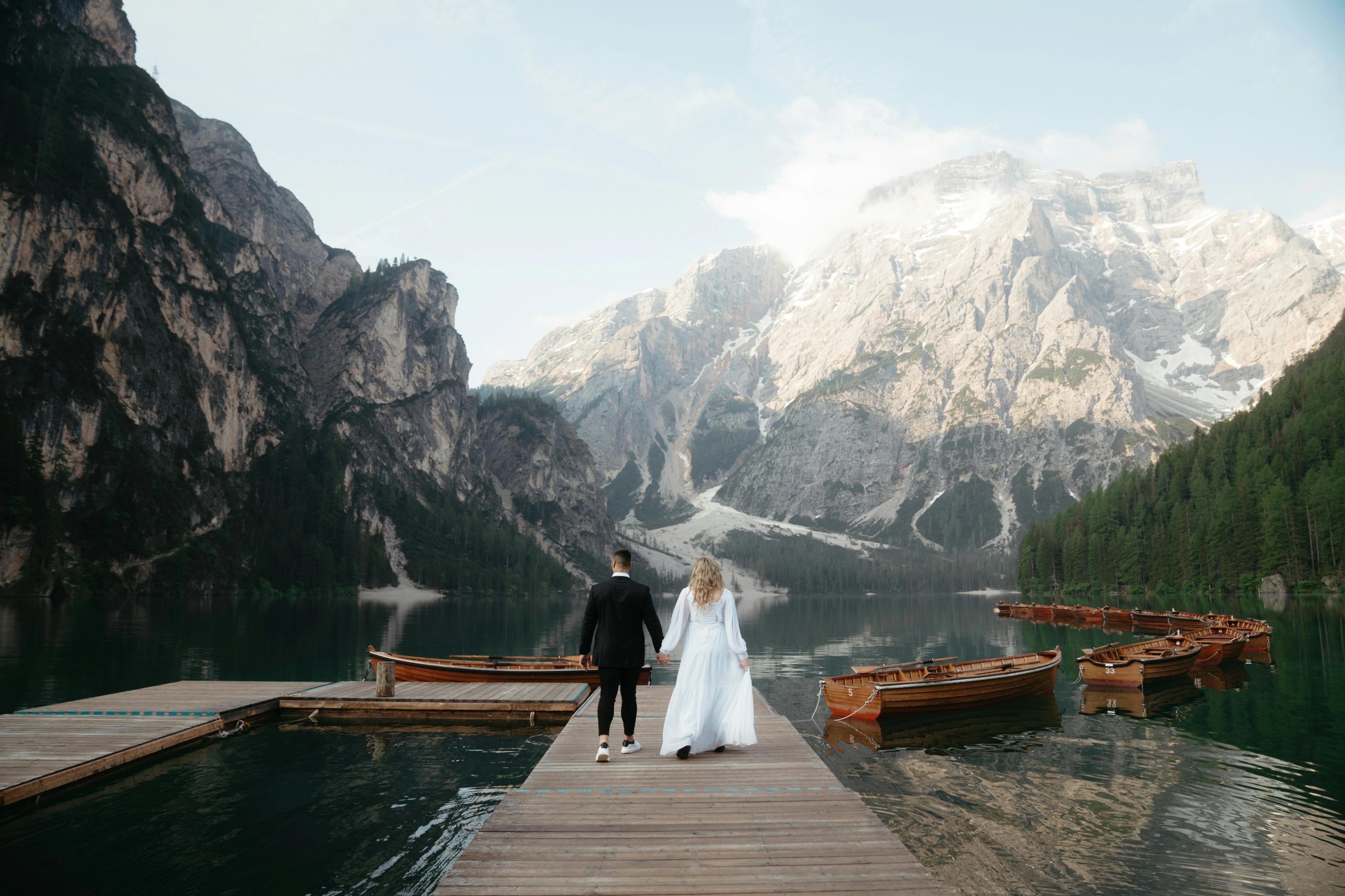 Mountain lake wedding venue with a wooden boardwalk at dusk