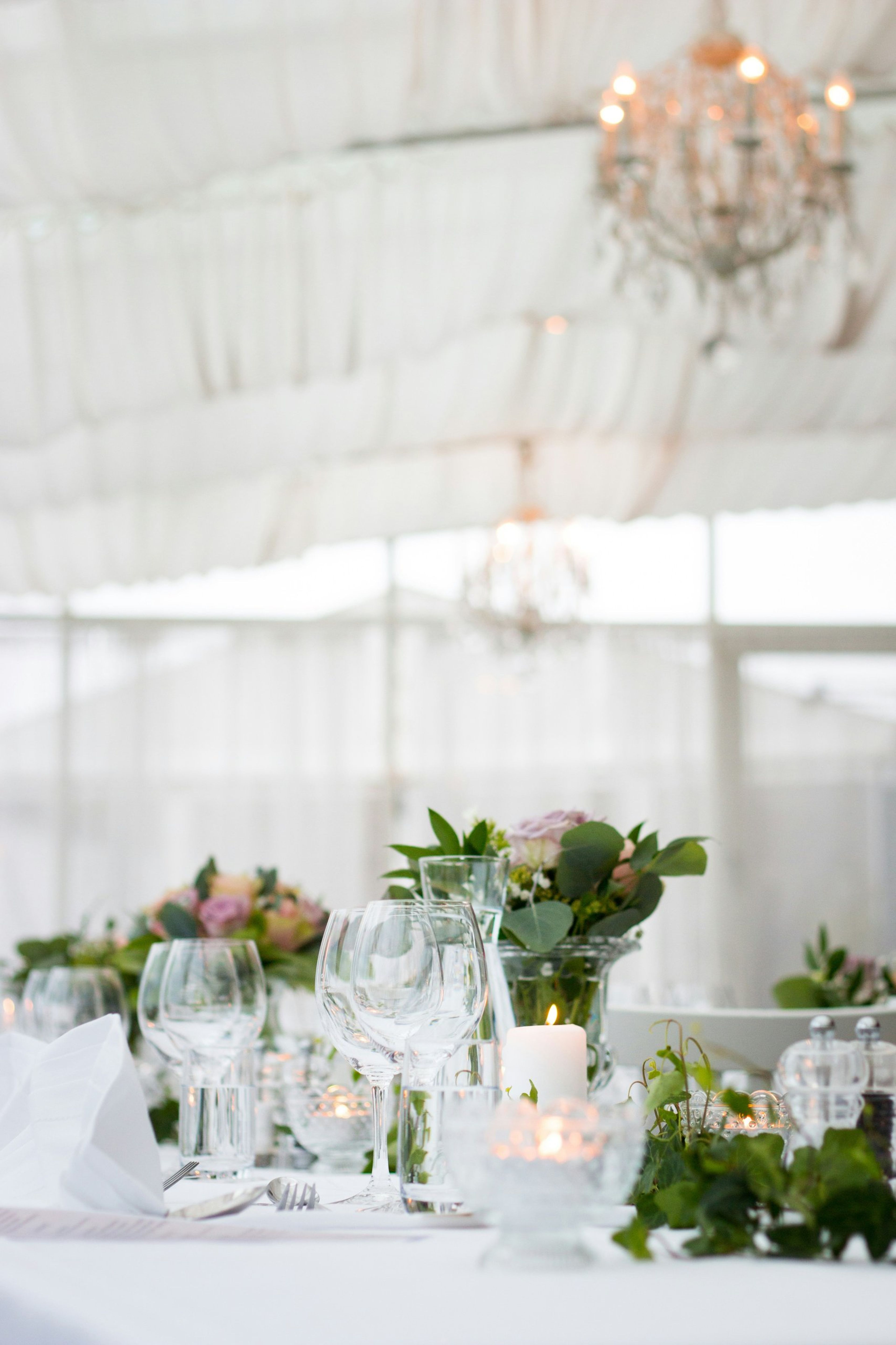 Reception table set with glassware and candles