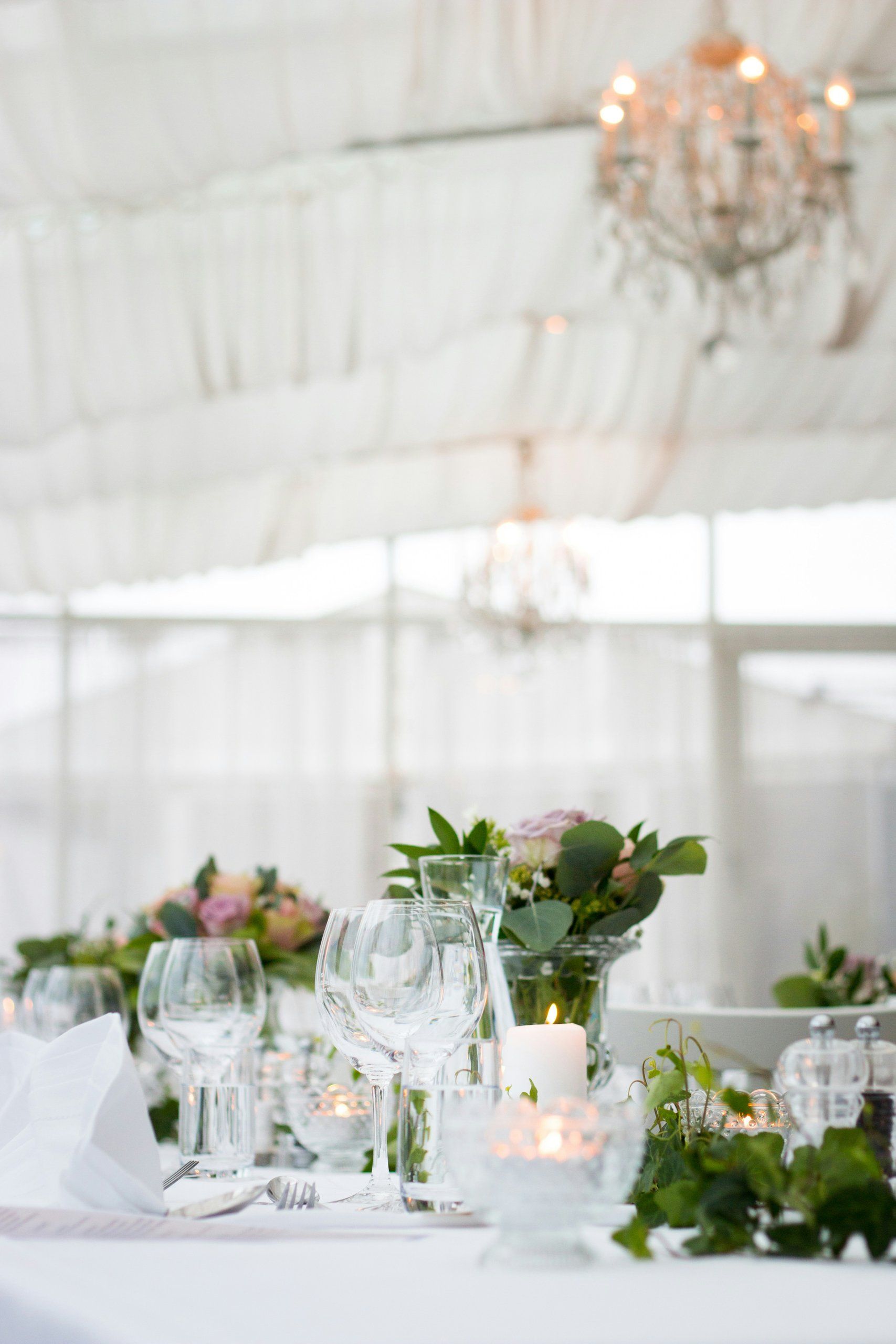 Reception table set with glassware and candles