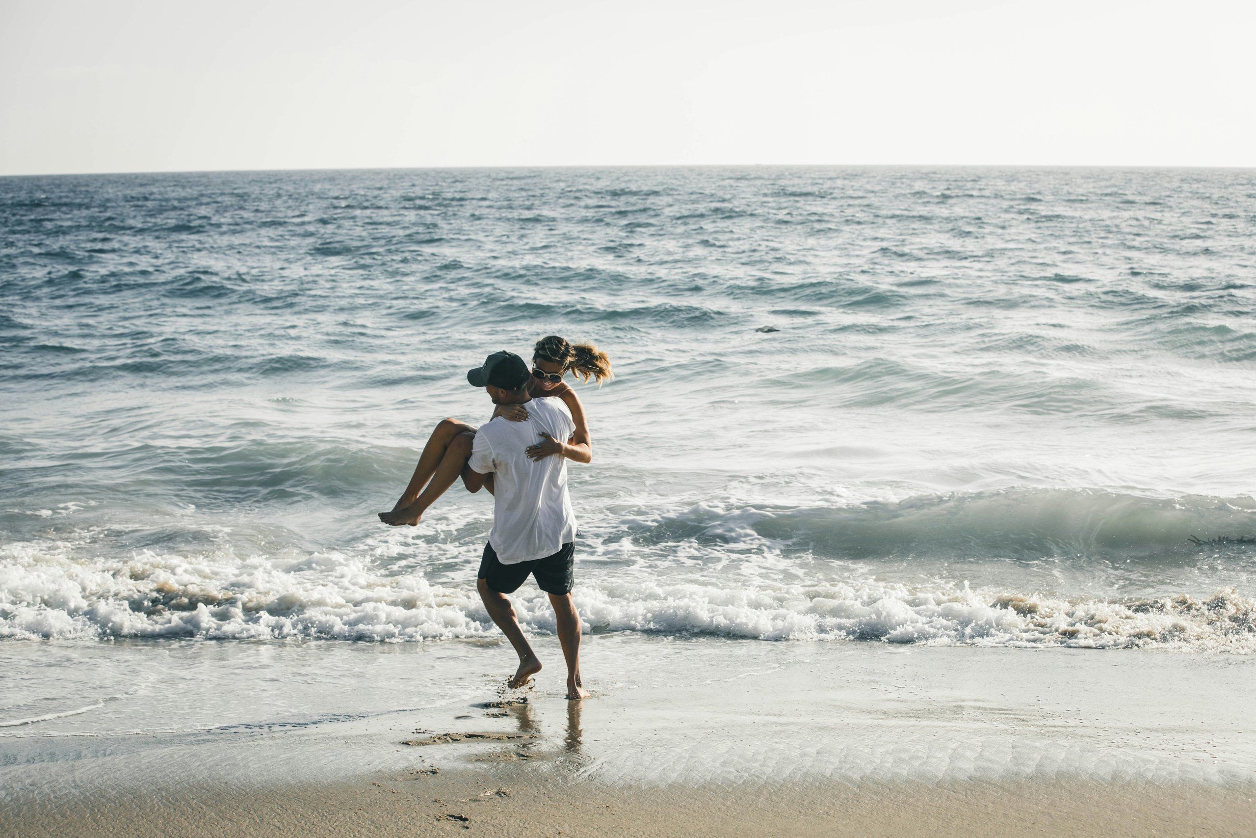 Couple on a beach at the water’s edge