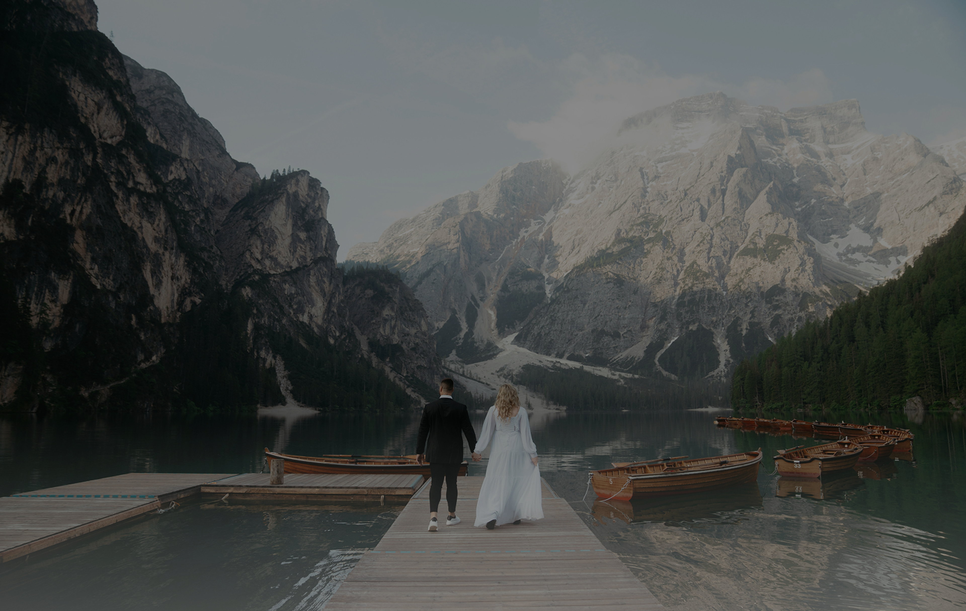 Mountain lake wedding venue with a wooden boardwalk at dusk