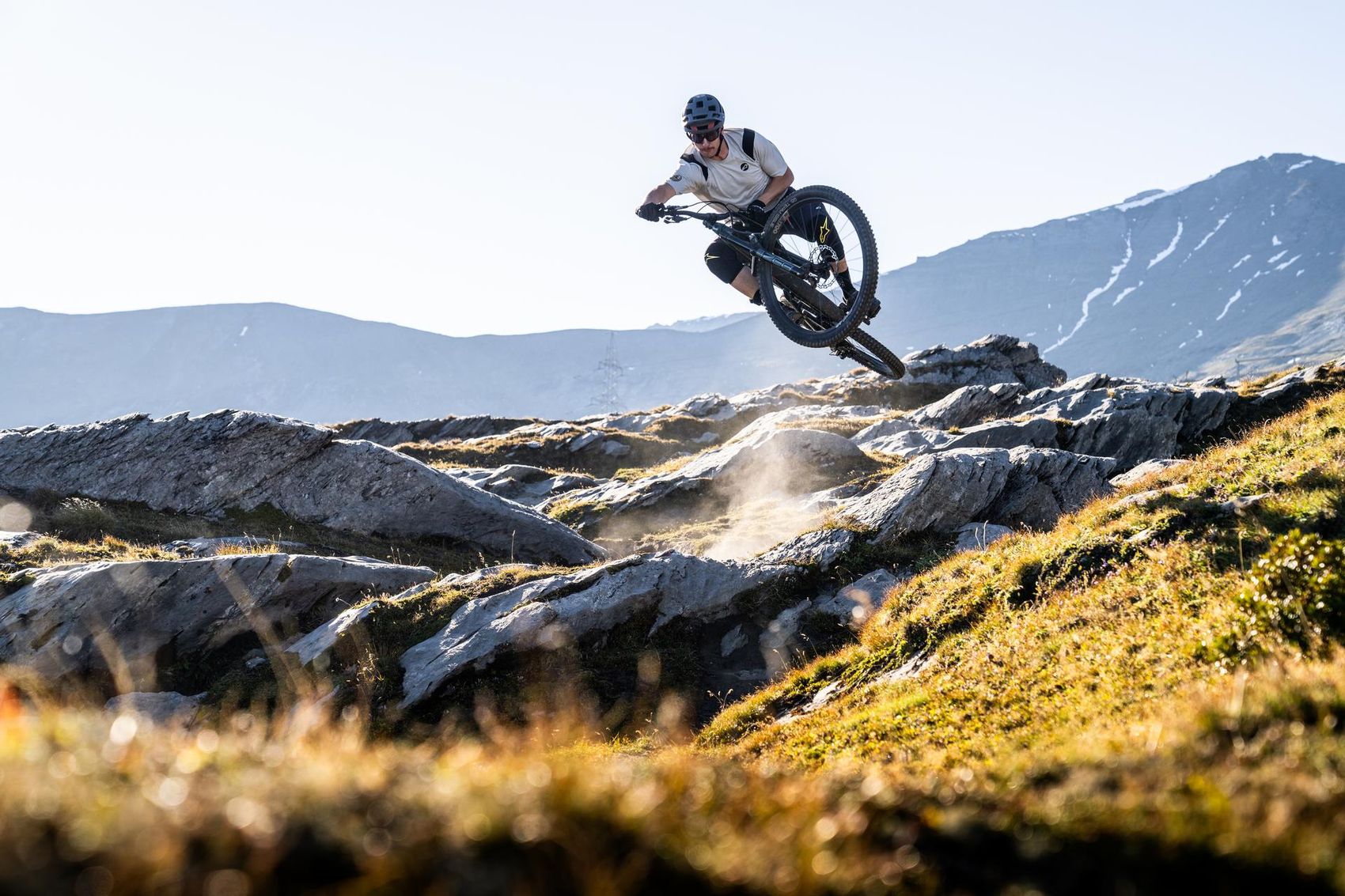 Biker jumps with bike over a stone