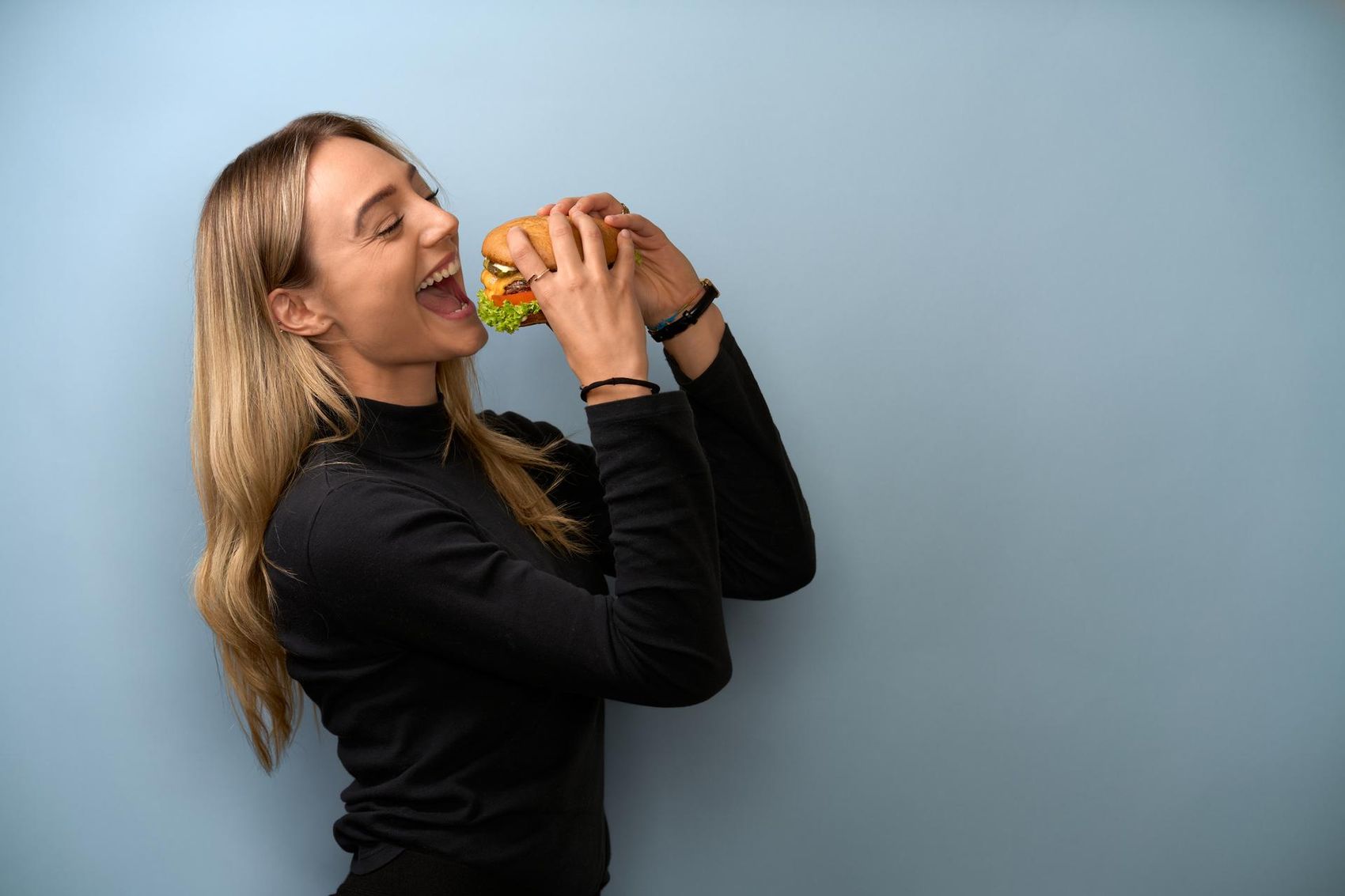 Woman bites into burger