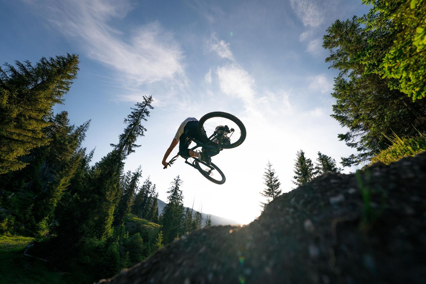Biker jumps over a hill