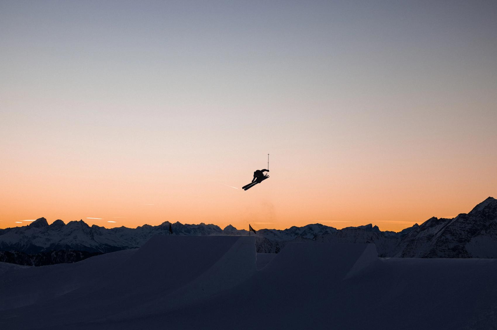 Skier at sunset in the snowpark
